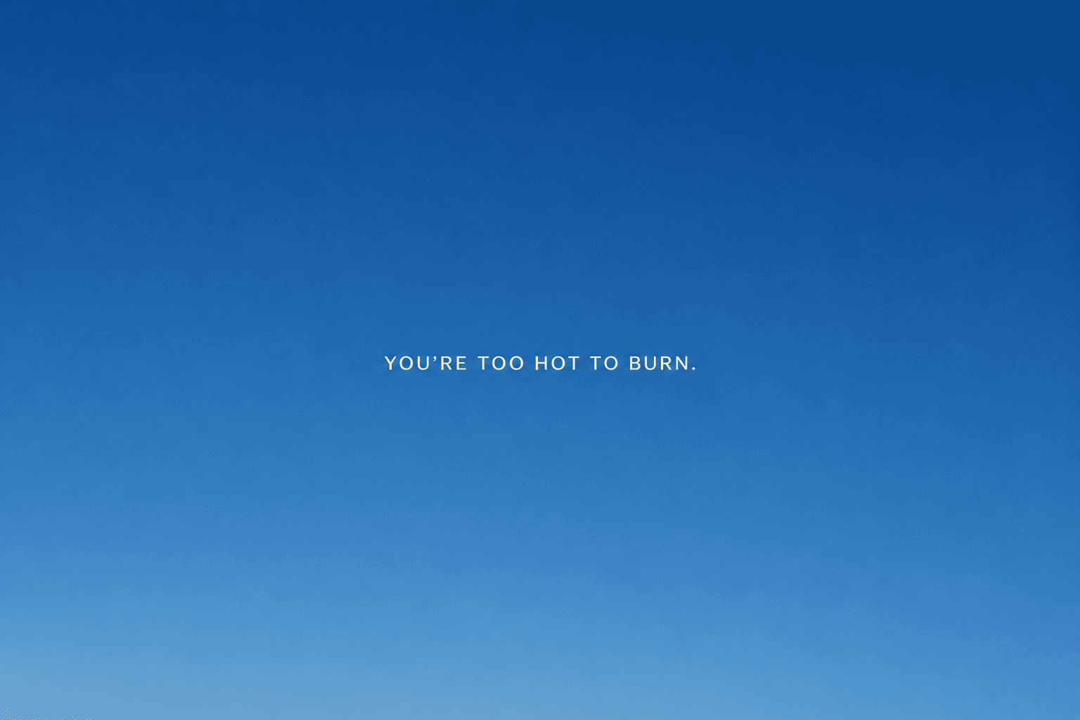 You're too hot to burn, written across a clear blue sky